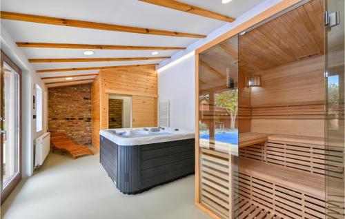 a bathroom with a soaking tub and a shower at Amazing Home In Bjelovar With Sauna in Bjelovar