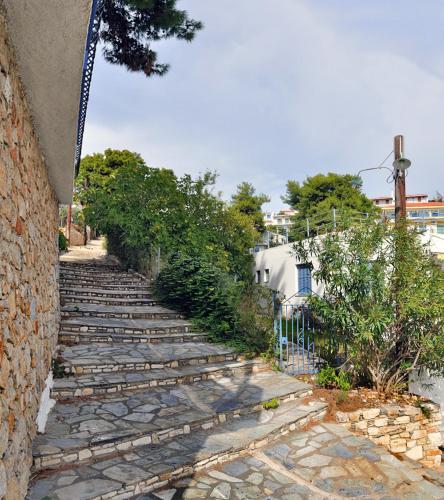 a set of stone stairs next to a building at Pension Dimitris in Votsi