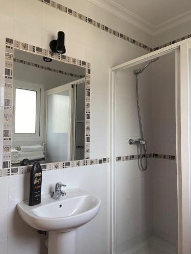 a bathroom with a sink and a shower at Hostal Los Mellizos in Conil de la Frontera