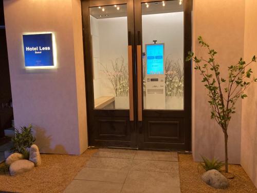 a front door of a building with a sign that reads wood lease at Hotel Less Seoul in Seoul