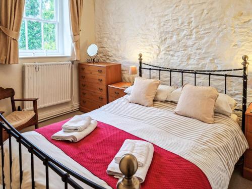 a bedroom with a large bed with towels on it at Old Belfield in Bowness-on-Windermere