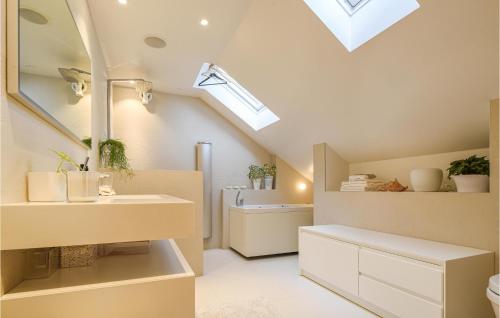 a bathroom with a sink and a skylight at Stunning Home In Gteborg With Sauna in Gothenburg