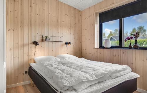 a bed in a room with a window at 5 Bedroom Cozy Home In Hadsund in Hadsund