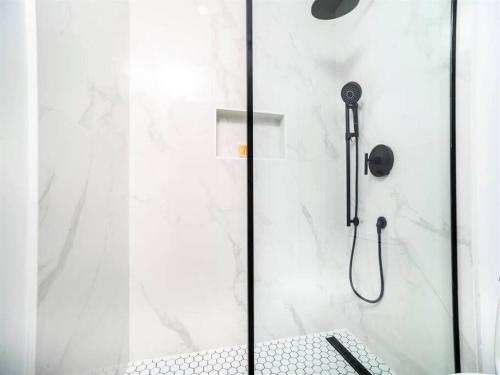 a shower with a glass door in a bathroom at Sunset Cove # 201 in George Town