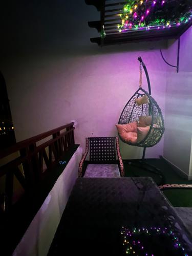 a room with a hammock and a chair with lights at The View Apartment in Hurghada