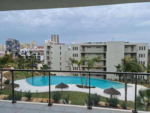 a view of a swimming pool from a balcony of a building at Celeste @ Oásis Mar in Portimão