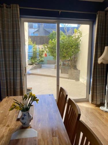 a dining room table with a vase of flowers on it at Loughview in Bangor