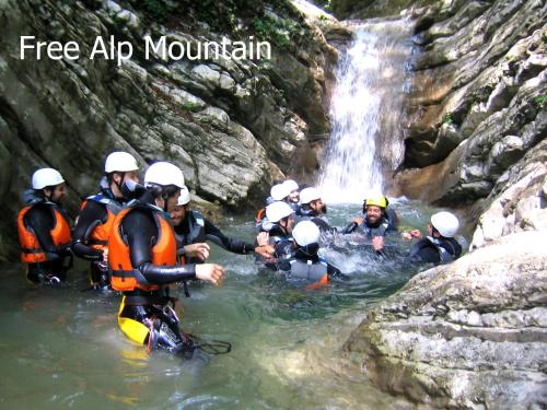 a group of people in the water in front of a waterfall at Agriturismo Terra E Sole in SantʼAmbrogio di Valpolicella
