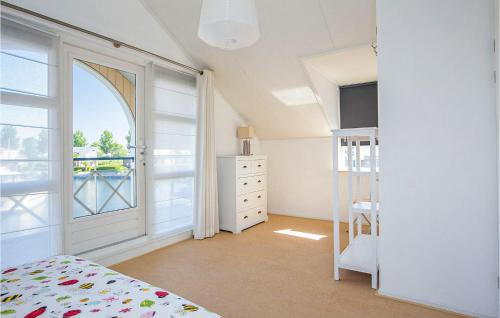 a bedroom with a bed and a large window at Amazing Home In Workum With Wifi in Workum