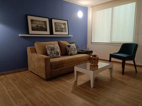 a living room with a couch and a table at Hotel Boutique Confort Suites in Popayan