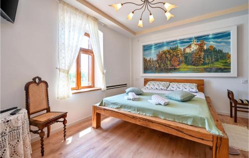 a bedroom with a bed and a painting on the wall at Stunning Home In Konjscina With House A Panoramic View in Husinec