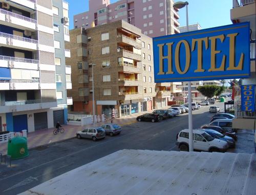 a sign for a hotel on a city street at Hotel Libertador in Cullera