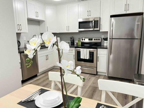 a kitchen with stainless steel appliances and white cabinets at Luxury condo in the heart of Midtown Sacramento in Sacramento