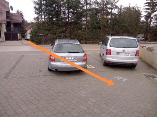 two cars parked next to each other in a parking lot at Silver Star Zlatibor in Zlatibor
