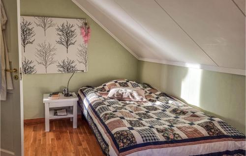 a small bedroom with a bed and a table at Pet Friendly Home In Rnnng With House Sea View in Rönnäng