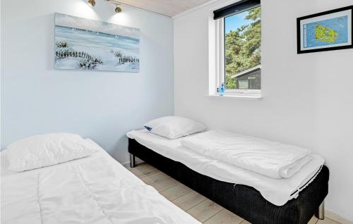 a bedroom with two beds and a window at Stunning Home In Nex With Sauna in Neksø