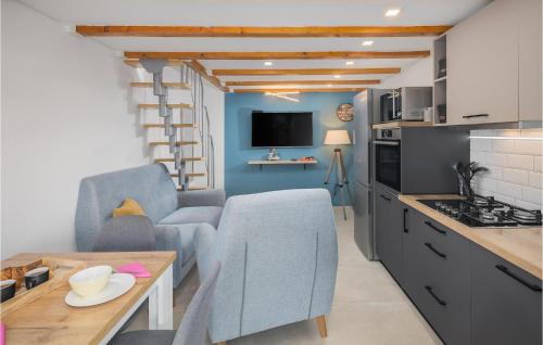 a kitchen and living room with two chairs and a table at Stunning Apartment In Vabriga With Wifi in Vabriga