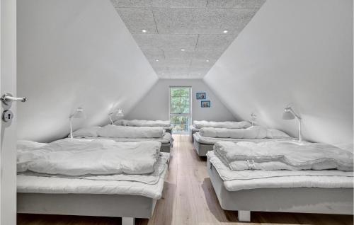 three beds in a room with white walls at Lovely Home In Ulfborg With Sauna in Øhuse
