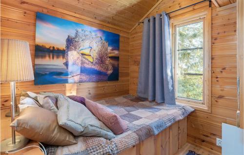a bedroom with a bed with a large picture on the wall at Stunning Home In yer With Sauna, Wifi And 3 Bedrooms in Øyer