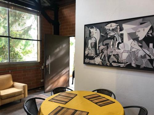 a yellow table and chairs in a room at Cabaña Campestre La Rayuela-Fuquene in Fúquene