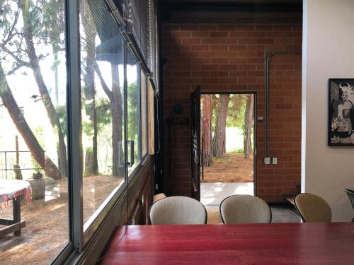 a room with a table and chairs and a mirror at Cabaña Campestre La Rayuela-Fuquene in Fúquene