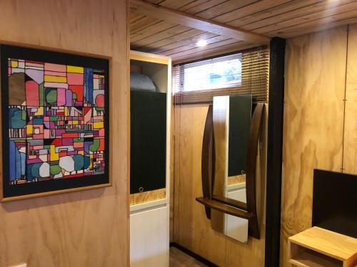 a bathroom with a stained glass window and a refrigerator at Cabaña Campestre La Rayuela-Fuquene in Fúquene