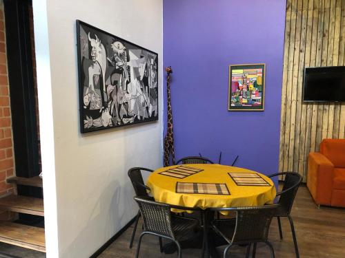 a dining room with a yellow table and chairs at Cabaña Campestre La Rayuela-Fuquene in Fúquene