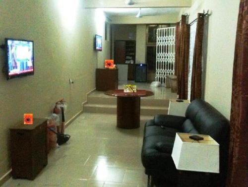 a living room with a couch and a table at Marrets International Hotel - "Express" in Cape Coast