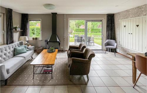 a living room with a couch and chairs and a table at Stunning Home In Sint Nicolaasga With Kitchen in Sint Nicolaasga