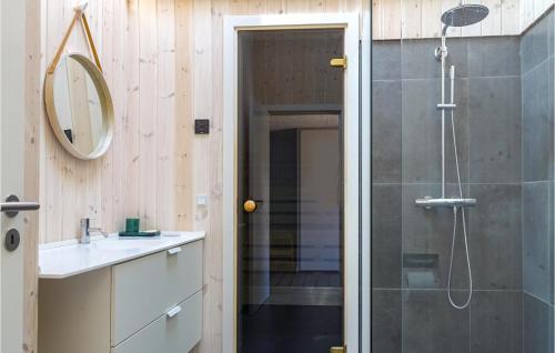 a bathroom with a shower and a sink and a mirror at Beautiful Home In Nex With Wifi in Snogebæk