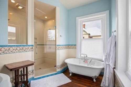 a bathroom with a tub and a shower at Summit Street Inns in Winston-Salem