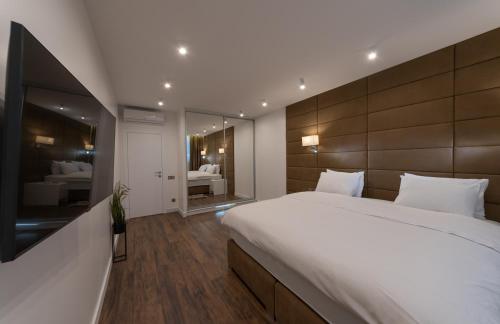a bedroom with a large bed and a large mirror at VICTORY-30 LUXURY APARTMENT CEnTER in Kyiv