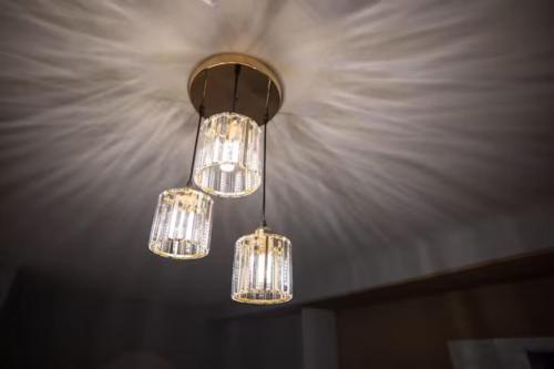 a cluster of lights hanging from a ceiling at Loft Pano Seaview Suite 2 Bedroom by The Only Bnb in Jelutong