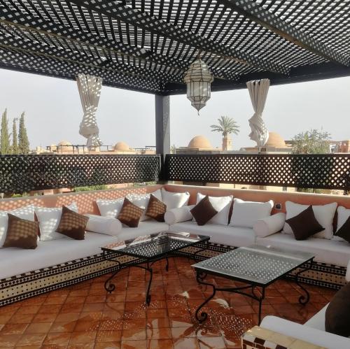 a living room with a white couch and a table at La Perle de l'Atlas by Golf Resort in Marrakech