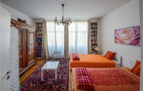 a bedroom with two beds and a chandelier at Holiday-business Residence in Taufkirchen