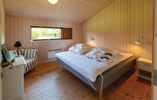 a bedroom with a bed in a room with a window at Gorgeous Home In Nykbing Sj With Kitchen in Ebbeløkke