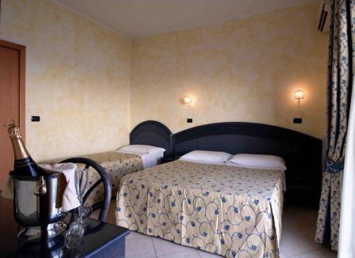 Postel nebo postele na pokoji v ubytování Hotel L'Approdo