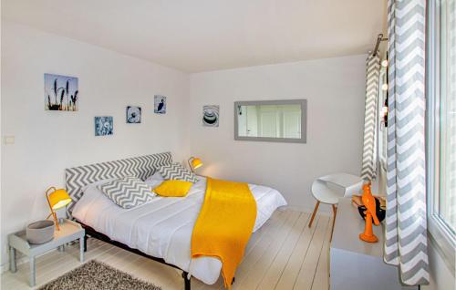 a bedroom with a bed with a yellow blanket at Nice Home In Montelimar With Wifi in Montélimar