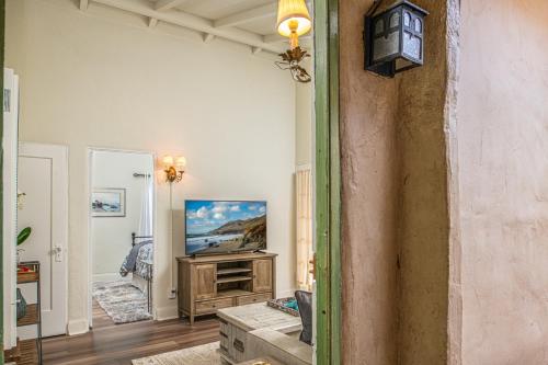 a living room with a tv on a wall at 3795 The Artist's Way apts in Carmel