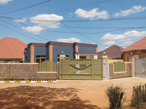 a rendering of a house with a fence at Cozy & Private 1 Bedroom self contained Kigali-Kanombe in Kigali