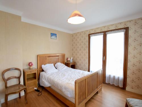 a bedroom with a bed and a chair and a window at Appartement Évian-les-Bains, 3 pièces, 5 personnes - FR-1-498-4 in Évian-les-Bains