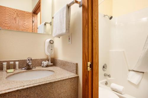 a bathroom with a sink and a phone at Super 8 by Wyndham West Fargo Main Ave ND in West Fargo