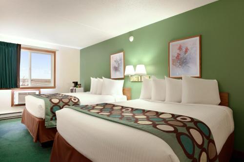 a hotel room with two beds and a window at Super 8 by Wyndham West Fargo Main Ave ND in West Fargo