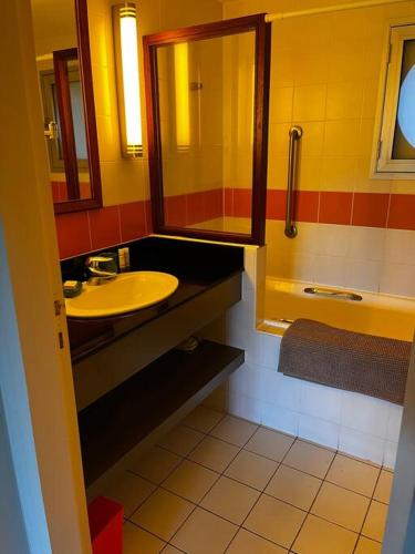 a bathroom with a sink and a mirror at The place to be in Noumea