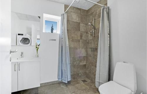 La salle de bains est pourvue d'une douche, de toilettes et d'un lavabo. dans l'établissement Lovely Home In Ringkbing With Kitchen, à Hee