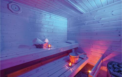 a sauna with candles and a person sitting in it at 3 Bedroom Beautiful Home In Brestovac in Novo Zvecevo