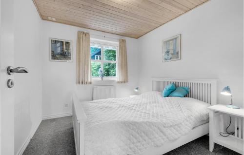 a white bedroom with a bed and a window at Amazing Home In Eg With Kitchen in Egå