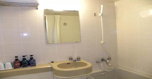 a bathroom with a sink and a toilet and a mirror at Yonezawa - Hotel / Vacation STAY 14338 in Yonezawa