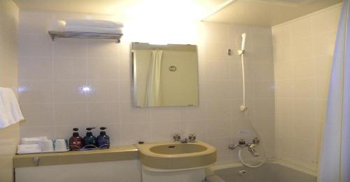 a bathroom with a sink and a toilet and a mirror at Yonezawa - Hotel / Vacation STAY 14342 in Yonezawa