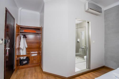 a bathroom with a large mirror and a closet at King Grand Boutique Hotel in Phnom Penh